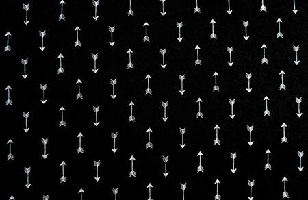 Black fabric background texture. close up blue fabrics cloth with white arrows pattern and template for an empty surface and wallpaper. Beauty and fashion concept. Vintage white arrow for abstract.の写真素材