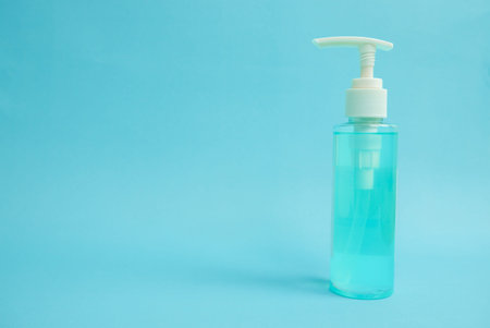 Coronavirus outbreak and COVID-19 prevention medical alcohol gel bottle on blue background for...