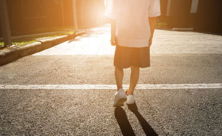 Children school start line on road background at sunset light. Asian child run race. Kids in uniforms walking shoes. Creative and idea success motivation concept. Childhood dream.の写真素材