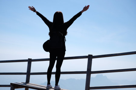 Asian woman in casual sweater of amazing landscape with mountains landscape background. Happy traveler female during vacation in Thailand.の写真素材