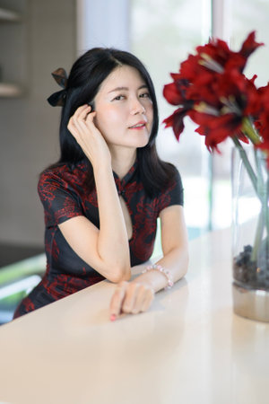 Asian woman wearing traditional cheongsam dress. Portrait of female model. Happy Chinese New Year.の写真素材