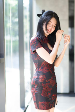 Asian woman wearing traditional cheongsam dress. Portrait of female model. Happy Chinese New Year.の写真素材
