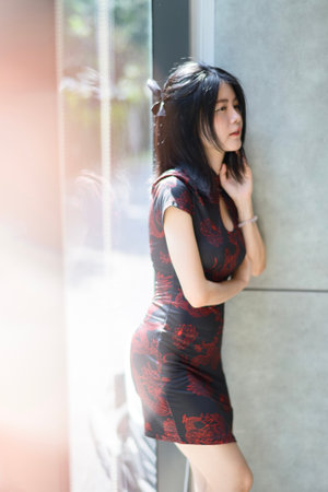 Asian woman wearing traditional cheongsam dress. Portrait of female model. Happy Chinese New Year.の写真素材