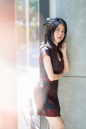 Asian woman wearing traditional cheongsam dress. Portrait of female model. Happy Chinese New Year.の写真素材