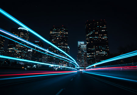traffic in city at night with blur light trails on the streetの素材