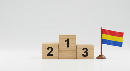 A simple podium made of wooden blocks numbered 1, 2, and 3, accompanied by a colorful flag, symbolizing success and achievement in a minimalist setting.の素材