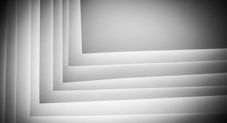 A minimalist black and white abstract background featuring layered geometric shapes. The sharp angles and soft shadows create a sense of depth and modern architectural design.の素材