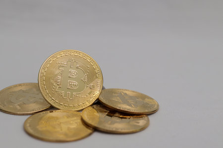 a pile of bitcoin over gray background. Cryptocurrency trading conceptの写真素材