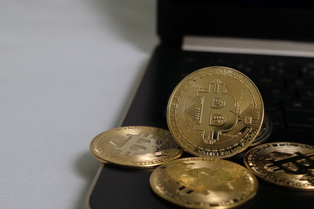 A pile of bitcoin arranged on the laptop. Cryptocurrency trading conceptの写真素材