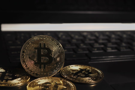 A pile of bitcoin arranged on the laptop. Cryptocurrency trading conceptの写真素材