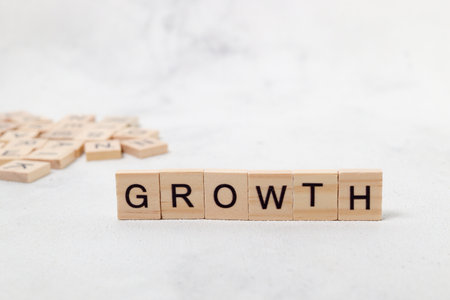 Top view of Growth word on wooden cube letter block on white background. Business conceptの写真素材