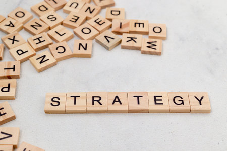 Top view of Strategy word on wooden cube letter block on white background. Business conceptの写真素材