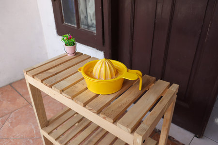 Yellow juicer on wooden table