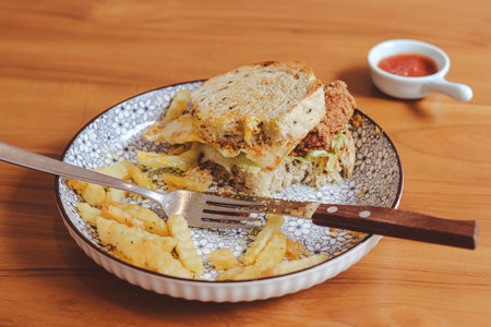 Whole wheat sandwich toast with crispy chicken, sunny side egg, and sauce. Breakfast concept in the morningの写真素材