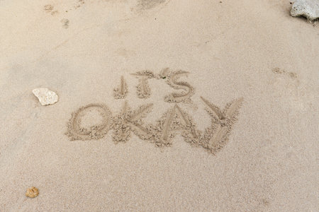 Motivation quotes it is okay written in the sand of the beachの写真素材