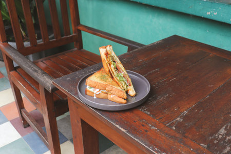 Sandwich toast with crispy chicken, sunny side egg, and sauce. Breakfast concept in the morningの写真素材