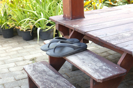 Black flip flops outside the houseの写真素材