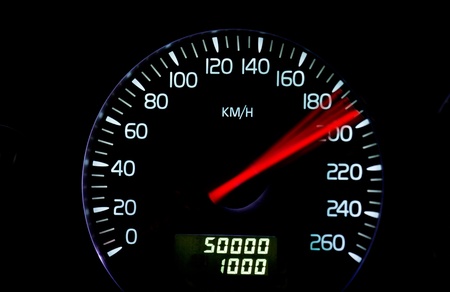 Speedometer at high speed with red index and odometerの写真素材