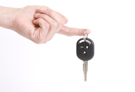 holding automobile keys isolated on white background