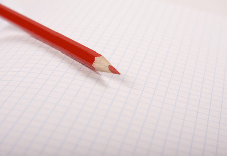 Red pencil laying on the notebookの写真素材