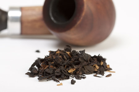 Smoking pipe and tobacco isolated on white