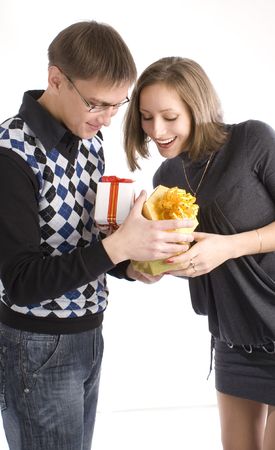 Man and woman giving the gifts to each otherの写真素材