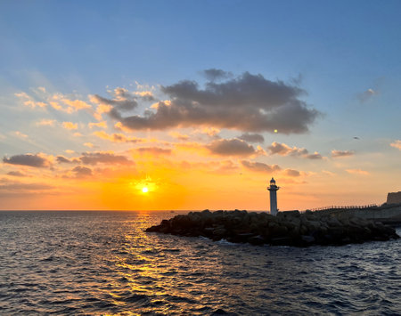 Beautiful sunset at the lighthouse in the port of Trieste, Italyの写真素材