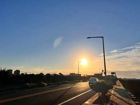 Sunset on the road in the city. The sun goes down.
