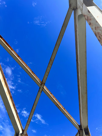 Steel structure of bridge with blue sky background, closeup of photoの写真素材