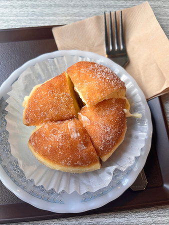 Donuts with icing sugar on a plate, selective focus.