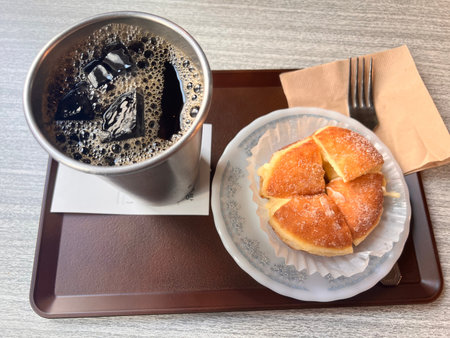Coffee and croissant on the table in the cafe
