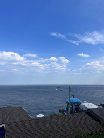 View of the sea from the terrace of a house with a blue skyの写真素材