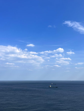 Seascape with blue sky, white clouds and sea boat.の写真素材
