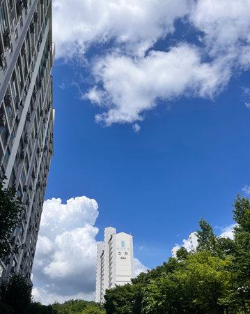 Modern office building in the city with blue sky and white clouds.