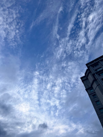 Blue sky and white clouds in the city, photo as a backgroundの写真素材