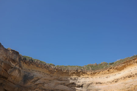 cliff on the algarve coast in portugal with blue sky