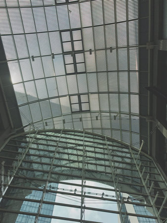 Interior of a modern building with glass roof, view from below