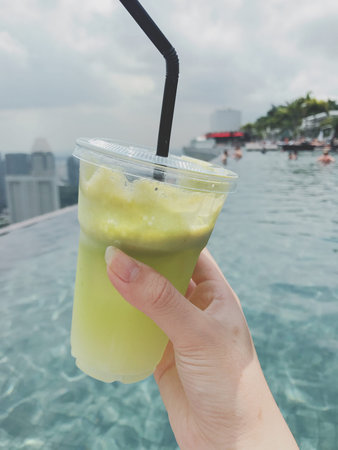 Iced green tea on the edge of the swimming pool in Thailand.