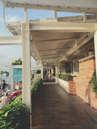 Tourists walk along the promenade in Bangkok, Thailand.