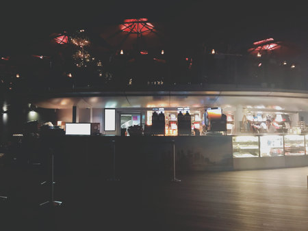 Coffee shop at night with lights and reflections on the glass