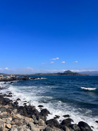Seascape with rocks and blue sky. Beautiful natural background.の写真素材