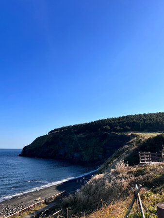 Coast of the North Sea with blue sky and white clouds.の写真素材