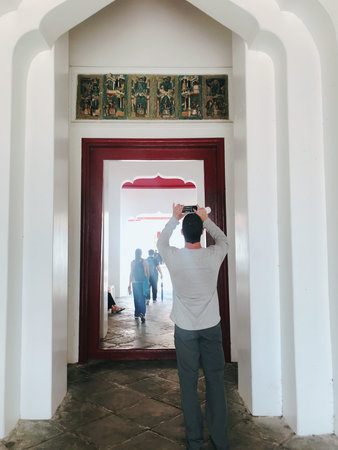 Man looking at the door of a mosque in morocco.