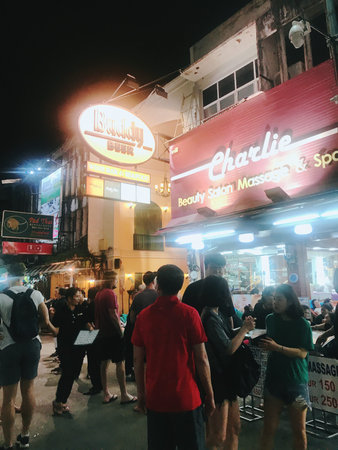 Unidentified people walking in the night street. Bangkok is the capital and most populous city of...