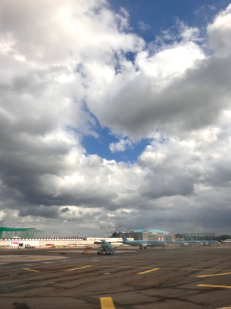 Airplane on the runway of the airport with cloudy sky background.の写真素材