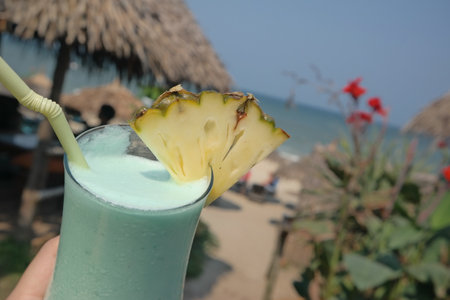 Pineapple smoothie on the beach in the tropics.の写真素材