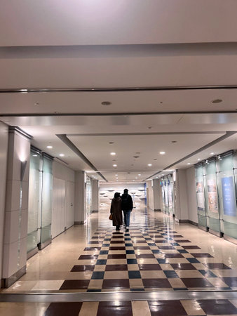 Interior of a modern shopping mall with people walking in the corridorの写真素材
