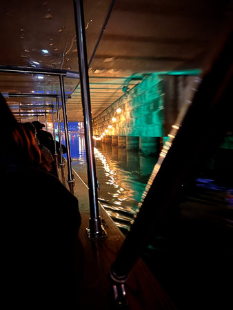 Boat trip in the city at night on a rainy day.