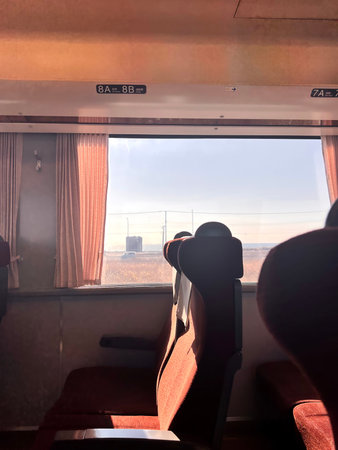 Interior of a train with seats and a view from the window