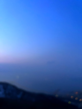 Blurred view of mountains and blue sky during sunset. Abstract background.の写真素材
